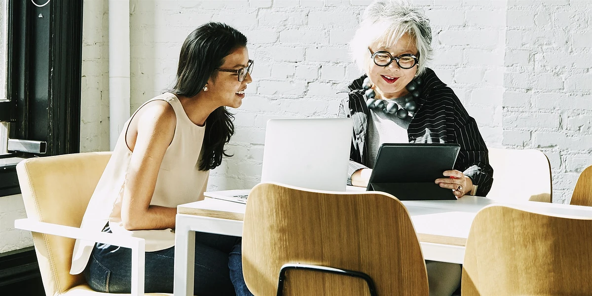 two women watching ipad